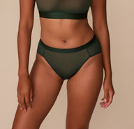 Front view of Victoria wearing the ComfortMesh™ Highwaist Brief in Sequoia, highlighting the supportive waistband and smooth sheer coverage across the hips. sizing: Victoria wears size Medium