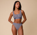 Full body front view of Ally modeling the ComfortMesh™ Highwaist Brief and matching ComfortMesh™ Scoop Bralette in Steel. The image shows the lightweight, breathable mesh set styled together.