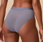 Close-up back angle of Ally wearing the ComfortMesh™ Highwaist Brief in Steel. The image draws attention to the high leg opening and the soft, barely-there mesh fabric.