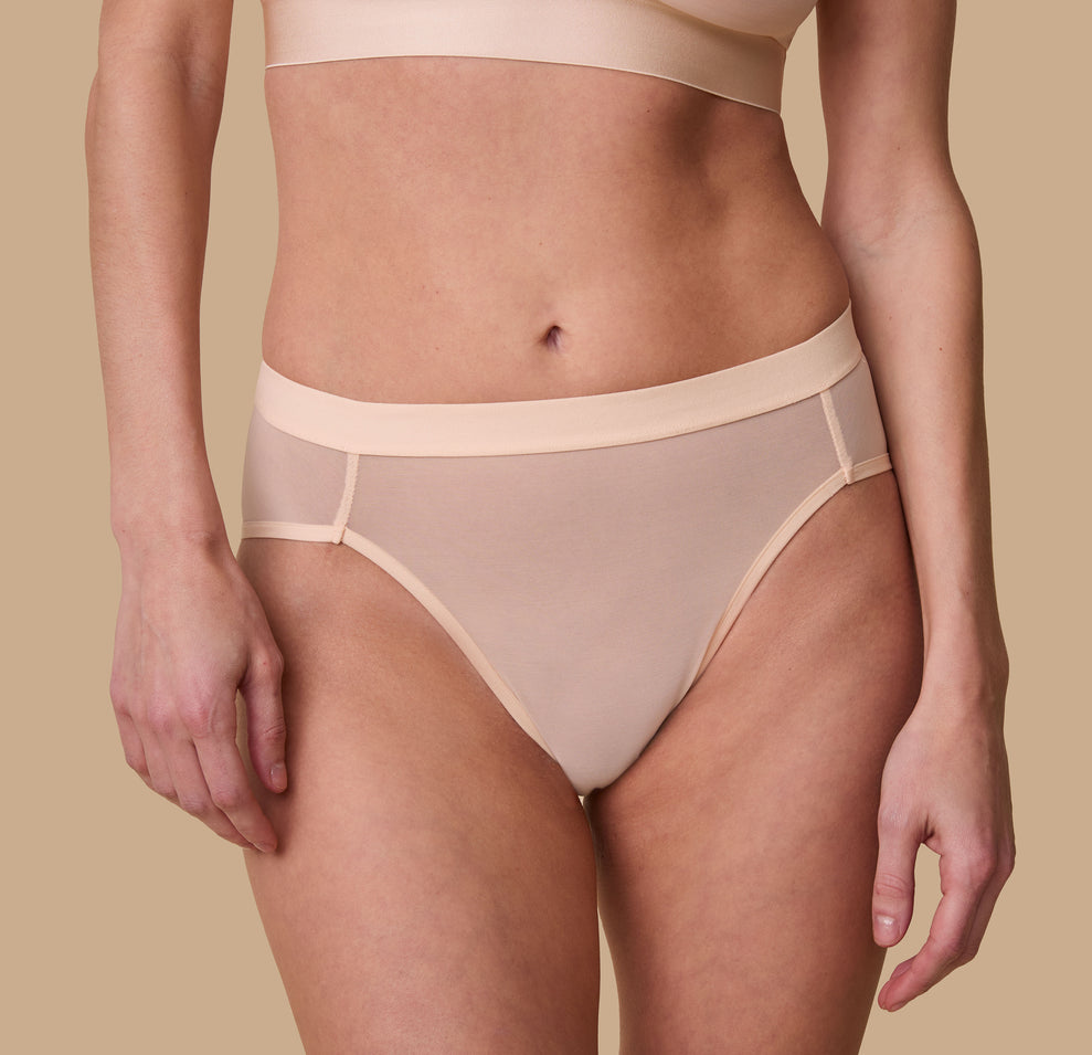 Front close-up view of the ComfortMesh™ Highwaist Brief in Pearl on a second model. The sleek waistband and flattering seams provide a polished and comfortable look. 