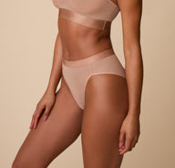 Side view of the Taupe Highwaist Briefs on a model, emphasizing the contouring fit and elegant high-leg design.