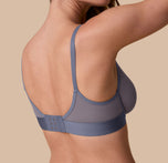 Back view of Gracie wearing the ComfortMesh™ Plunge Bra in Steel. The image focuses on the adjustable straps and hook-and-eye closure, with smooth mesh back panels.