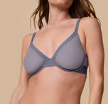 Close-up angled view of Gracie wearing the ComfortMesh™ Plunge Bra in Steel. The image draws attention to the soft mesh texture and deep V cut of the bra.