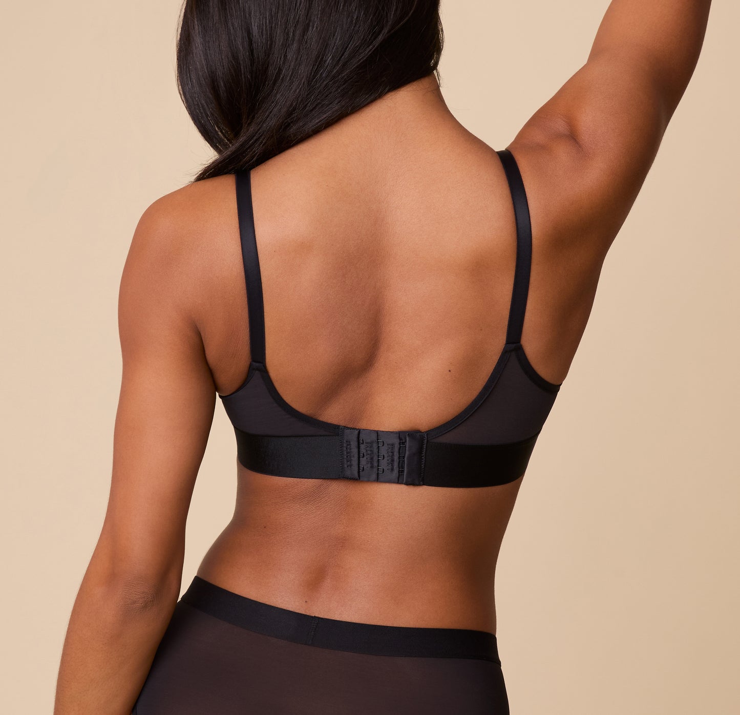 Rear view of Ally wearing the ComfortMesh Plunge Bra in Black, showcasing the smooth straps and supportive band for all-day comfort.