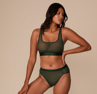 Victoria standing in the ComfortMesh™ Scoop Bralette and Highwaist Brief in Sequoia. The coordinated mesh set showcases soft, stretchy coverage and a modern silhouette.