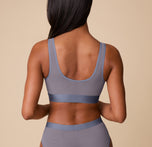 Back view of Ally in the ComfortMesh™ Scoop Bralette in Steel. The image features the U-shaped back design and supportive mesh band that lays flat against the skin.