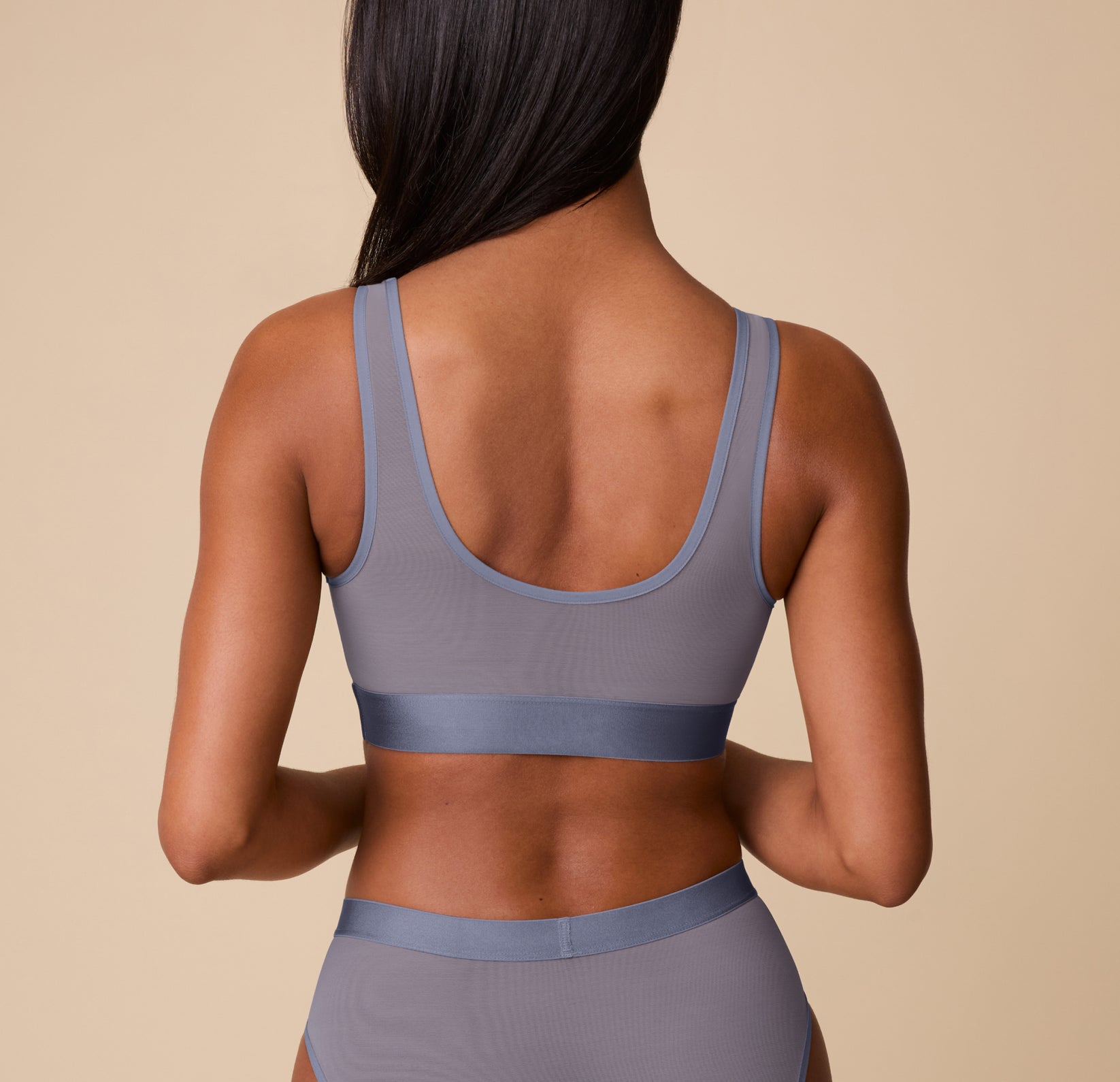 Back view of Ally in the ComfortMesh™ Scoop Bralette in Steel. The image features the U-shaped back design and supportive mesh band that lays flat against the skin.