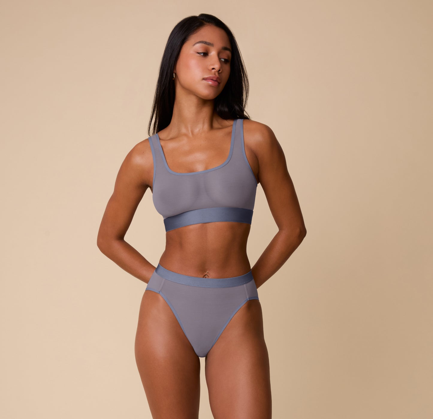 Full front view of Ally modeling the ComfortMesh™ Scoop Bralette and Highwaist Brief in Steel. The image showcases the set’s sheer, lightweight design and sporty yet soft structure.