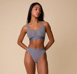 Full front view of Ally modeling the ComfortMesh™ Scoop Bralette and Highwaist Brief in Steel. The image showcases the set’s sheer, lightweight design and sporty yet soft structure.