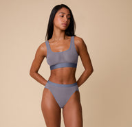 Full front view of Ally modeling the ComfortMesh™ Scoop Bralette and Highwaist Brief in Steel. The image showcases the set’s sheer, lightweight design and sporty yet soft structure.