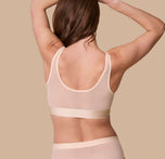 Rear view of the ComfortMesh™ Scoop Bralette in Pearl on a model. The back scoop neckline and smoothing band emphasize the supportive yet barely-there design.