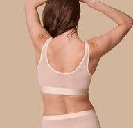 Rear view of the ComfortMesh™ Scoop Bralette in Pearl on a model. The back scoop neckline and smoothing band emphasize the supportive yet barely-there design.