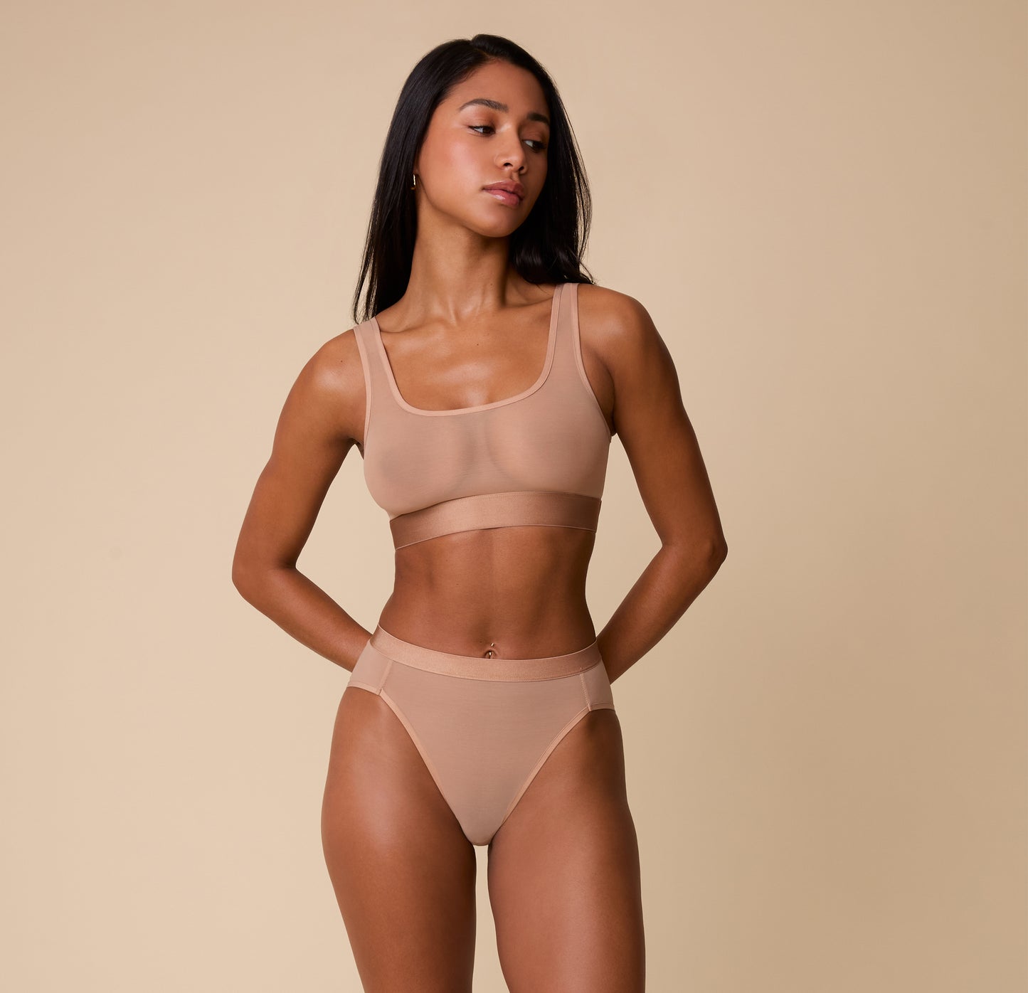 Full-body image of Ally wearing the ComfortMesh™ Scoop Bralette and matching high-waist brief in Taupe. The light fabric showcases the breathable and supportive qualities of the set.
