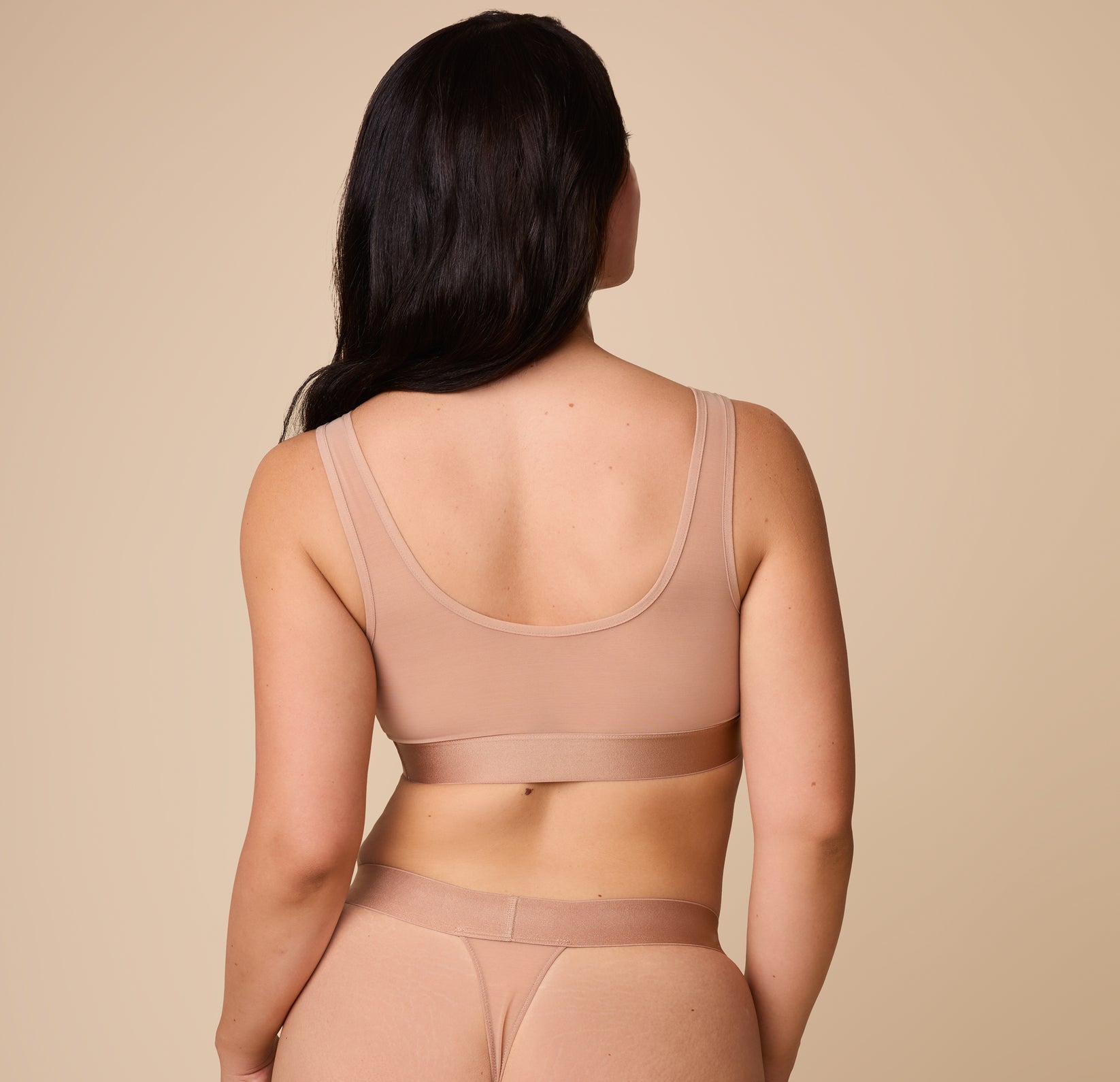 Back view of Emersyn wearing the ComfortMesh™ Scoop Bralette in Taupe. The soft, flexible band provides support while maintaining a breathable fit.
