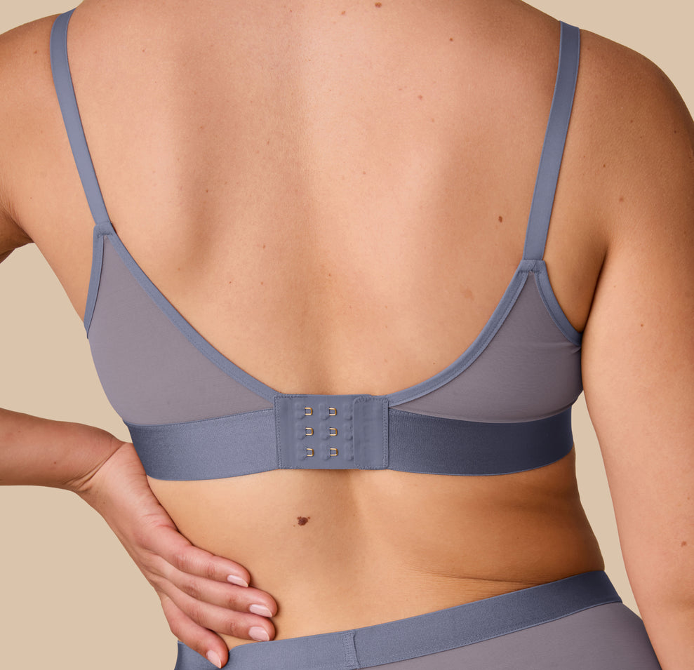 Back detail view of Emersyn in the ComfortMesh™ Triangle Bralette in Steel. Focus is on the clasp and wide back band for gentle, secure support.