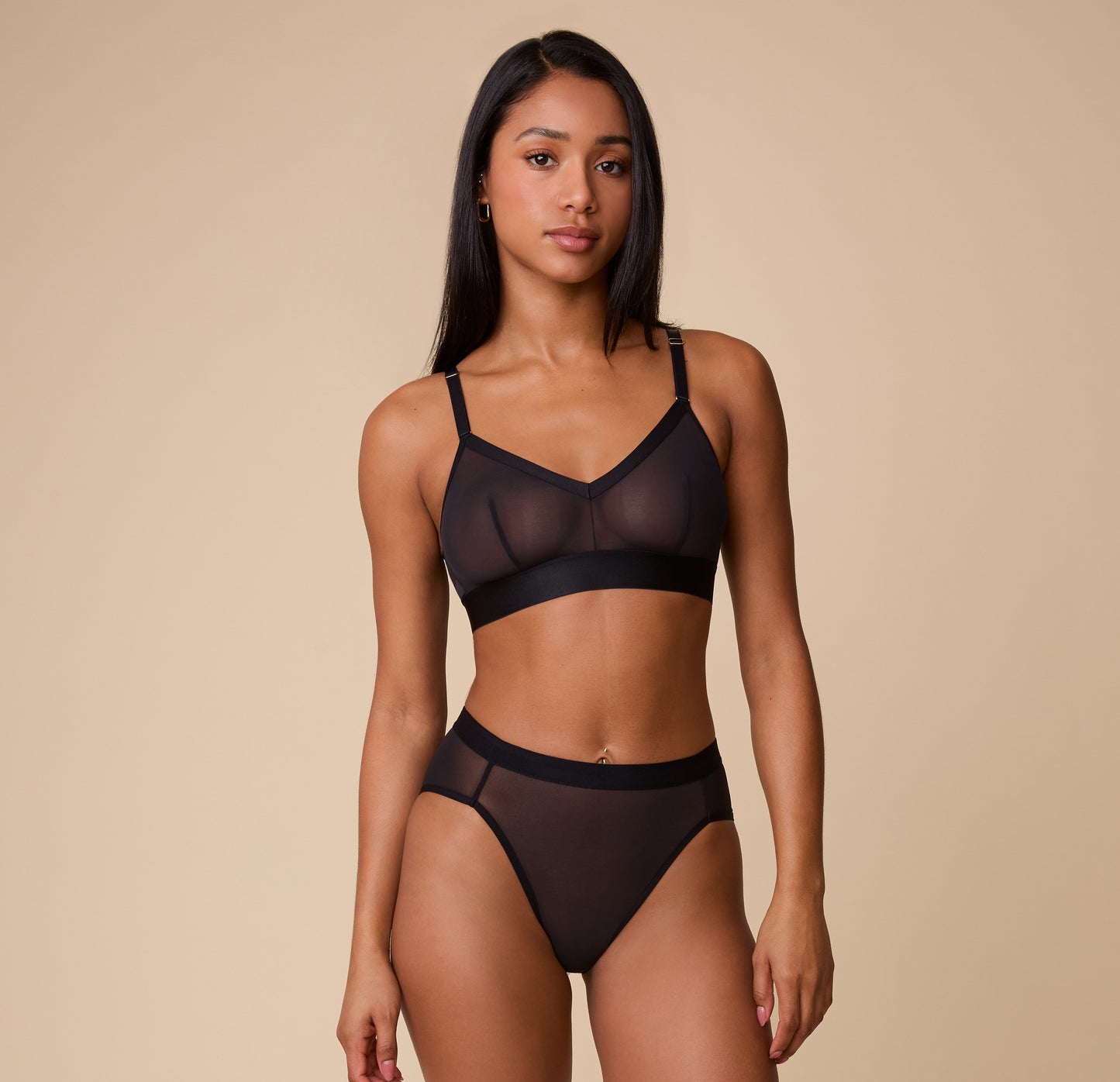 Full view of Ally modeling the ComfortMesh Triangle Bralette in Black with matching high-waist bottoms, showcasing the modern and chic silhouette.