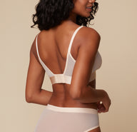 A back view of Ally wearing the ComfortMesh™ Triangle Bralette in Pearl. The soft straps and supportive band create a sleek and comfortable fit.