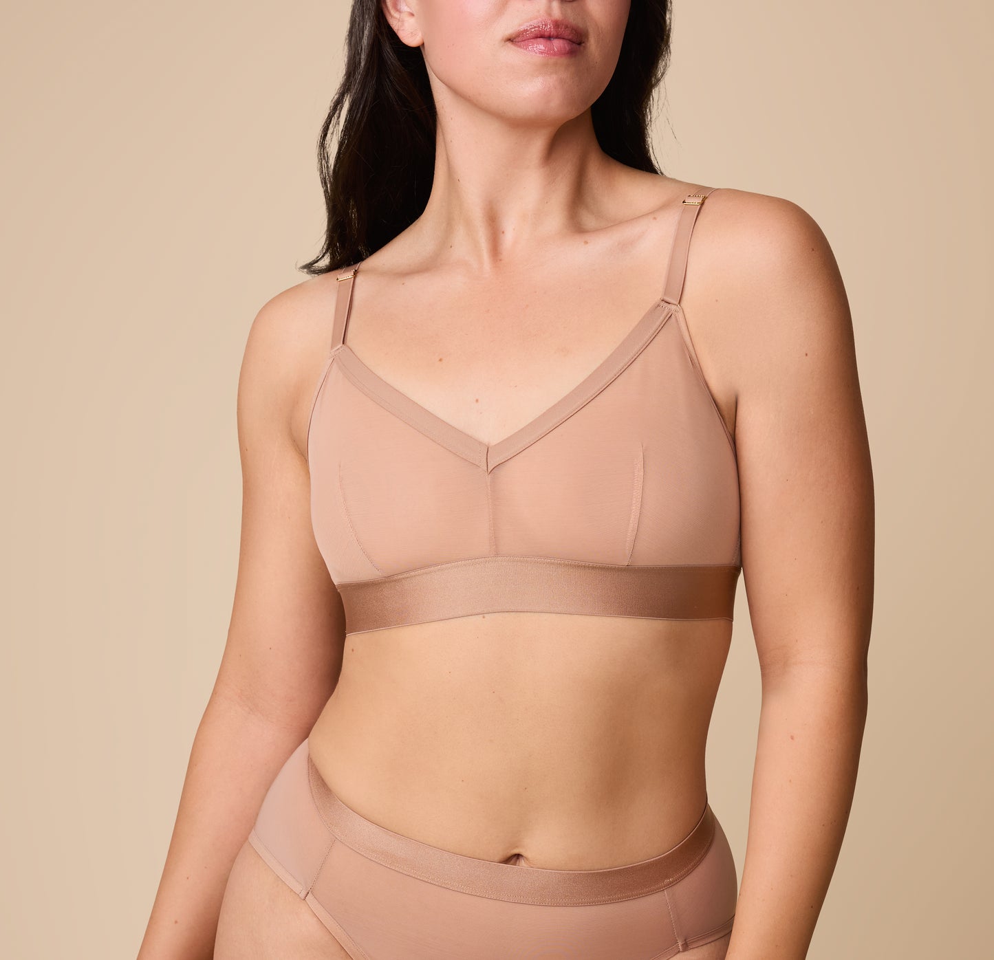 Close up of Emersyn wearing the ComfortMesh Triangle Bralette in Taupe. The front adjustable straps and triangle neckline are emphasized. sizing: Emersyn wears a size Medium