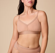Close up of Emersyn wearing the ComfortMesh Triangle Bralette in Taupe. The front adjustable straps and triangle neckline are emphasized. sizing: Emersyn wears a size Medium