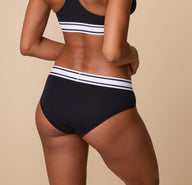 Back view of Ally in the Cloud Cotton Retro Hiphugger in Black. The image captures the soft, breathable cotton fabric and the curve-hugging fit.