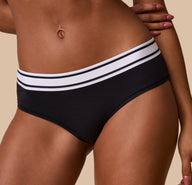 Detailed close-up of the waistband of the Cloud Cotton Retro Hiphugger in Black. The image captures the soft cotton texture and the black and white striped waistband.