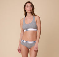 Full-body shot of Gracie modeling the Cloud Cotton Retro Hiphugger in Heather Charcoal with the matching Racerback Bralette. 