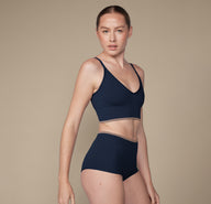 Model wearing the Lounge Rib Triangle Bralette and matching Lounge Rib Boyshort in the color True Blue