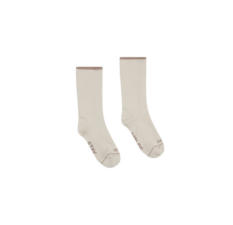 Flat lay of the Calf Sock in the color Oatmeal.
