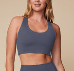 Megan standing confidently in the Flex Convertible Sports Bra and Flex High Rise Legging in Slate, facing forward to highlight the front fit. sizing: Megan wears size Medium