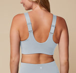 Megan in the Flex Convertible Sports Bra and Flex High Rise Legging in Thistle, turned to showcase the convertible back straps.