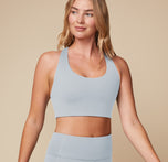 Close-up of Megan wearing the Flex Convertible Sports Bra in Thistle, focusing on the smooth fabric and supportive fit.