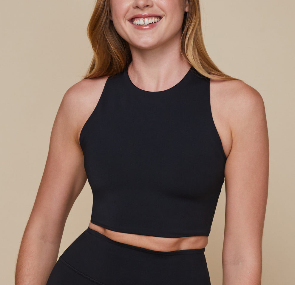 Erin smiles wearing the Flex Racerback Tank in the color Black with the matching Flex High Rise Bikeshort. sizing:Erin wears size Small