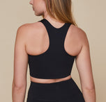 Back view of Erin wearing the Flex Racerback Tank in the color Black with the matching Flex High Rise Bikeshort.