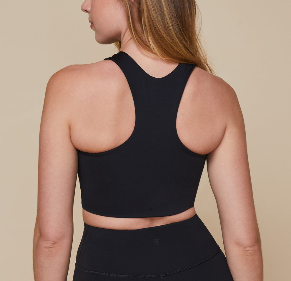 Back view of Erin wearing the Flex Racerback Tank in the color Black with the matching Flex High Rise Bikeshort.