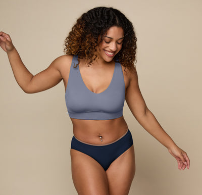 Model standing with her arms raised wearing the Bliss Bralette in the color Steel. sizing:Jade wears size Medium 