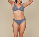 Kate is standing facing forward with both hands resting on her hips. She is wearing the Bliss Bikini in Steel, providing a full front view of the bikini. sizing:Kate wears size XL