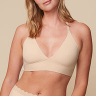 Front view of model wearing the Bliss Lace Halterneck Bralette in Beige with matching lace-trim underwear.