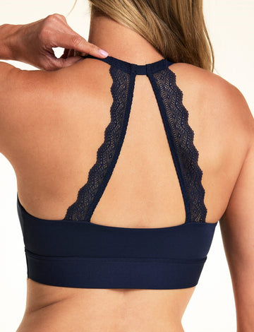 Back view of model wearing the Bliss Lace Halterneck Bralette in Navy, showcasing the signature lace back panel.