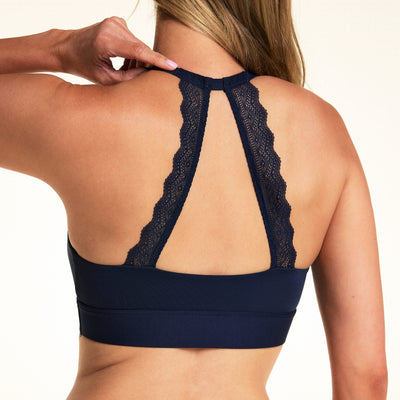 Back view of model wearing the Bliss Lace Halterneck Bralette in Navy, showcasing the signature lace back panel.