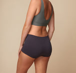 Back view of Lounge Rib Boyshort Underwear in the color Charcoal, paired with a Bliss Bralette in the color Stone.