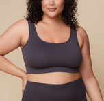Bianca stands facing forward, wearing the Lounge Rib Scoop Bralette and Lounge Rib Boyshort in Charcoal. The scoop neckline and ribbed texture highlight the bralette’s comfortable fit. sizing: Bianca wears size 2XL