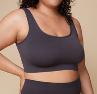 Close-up shot of Bianca wearing the Lounge Rib Scoop Bralette in Charcoal, emphasizing the soft ribbed texture and scoop neckline.