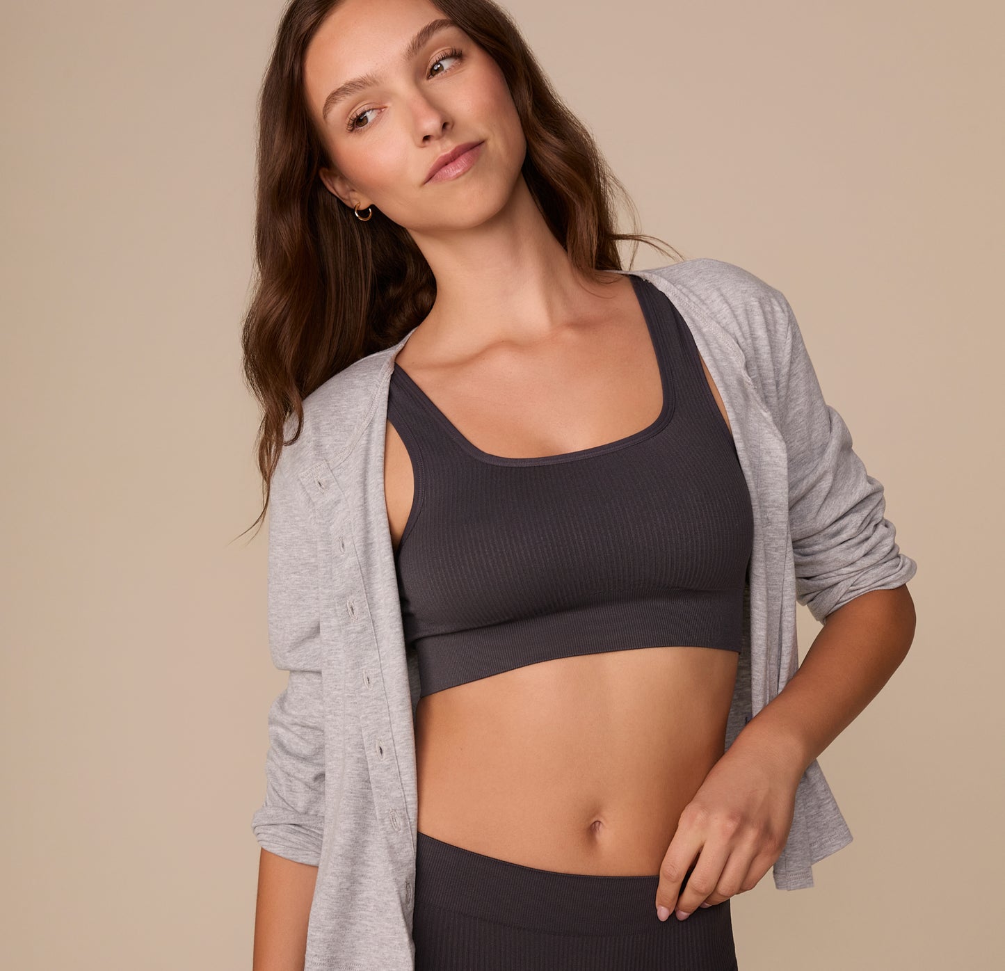 Alexis styled in the Lounge Rib Scoop Bralette in Charcoal with an open heather gray cardigan, demonstrating its versatility as both loungewear and casual wear.