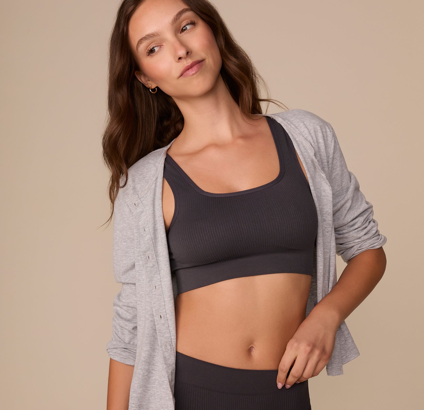 Alexis styled in the Lounge Rib Scoop Bralette in Charcoal with an open heather gray cardigan, demonstrating its versatility as both loungewear and casual wear.