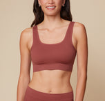 Anna stands facing forward, wearing the Lounge Rib Scoop Bralette and Lounge Rib Boyshort in Clay against a neutral backdrop. sizing: Anna wears size Small