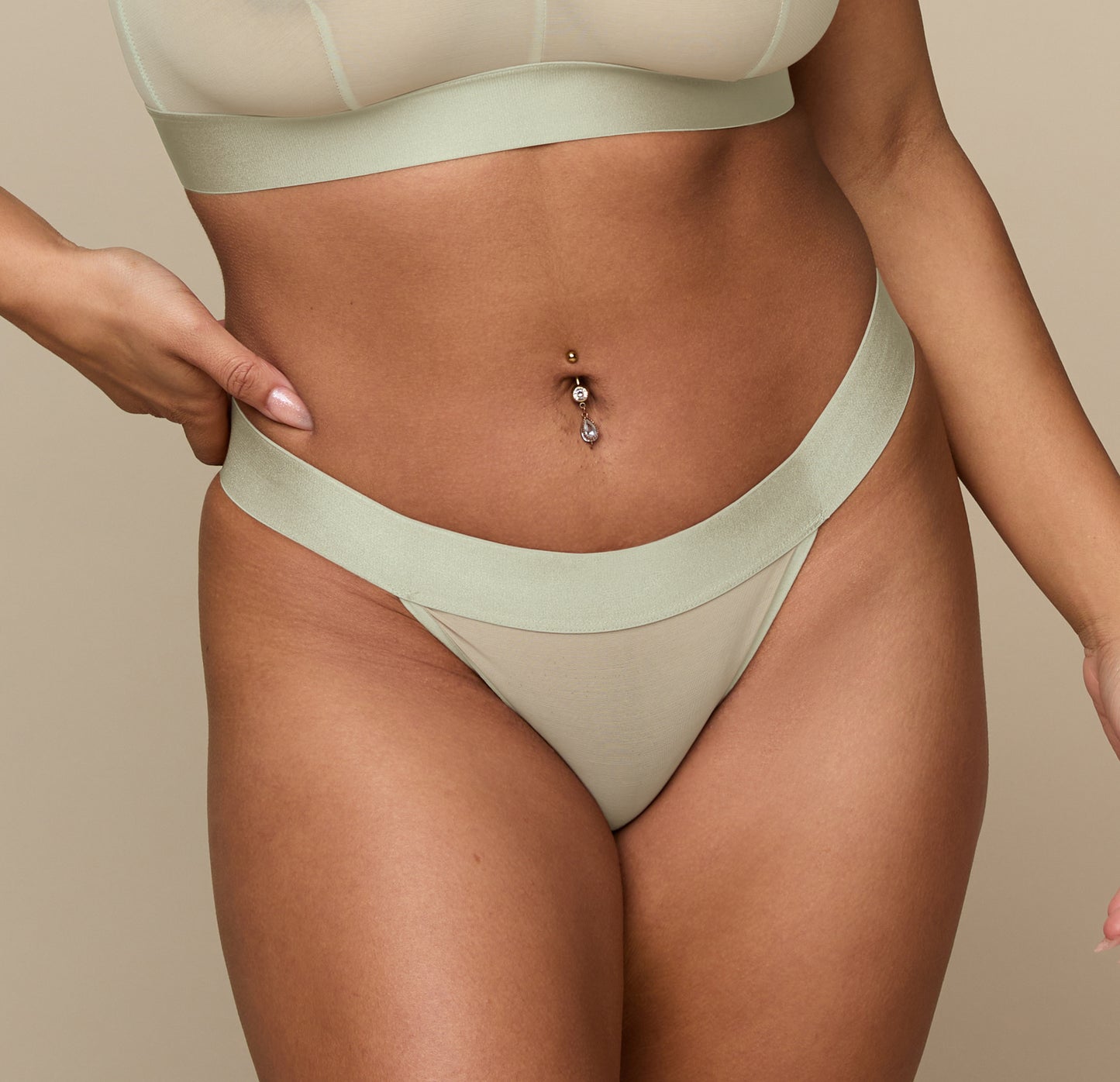 Close-up of the Luxe Thong in Moondust on the model, emphasizing the soft, lightweight fabric and comfortable waistband.