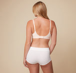 Back view of Megan wearing the Bliss Plunge Adjustable Bralette in Rose, displaying the standard strap configuration.