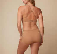 Back view of model Megan in the Bliss Boyshort in Tan, displaying the high-waisted fit and complete coverage.