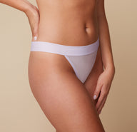 Close-up side view of the Luxe Thong in Opal on model Megan, focusing on the wide waistband