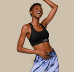 Woman wearing the Move Sports Bra in the color Black